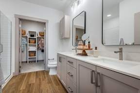 A bathroom with a white sink and a mirror above it.