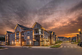 A large apartment complex is shown with a street in front of it.