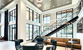 A large open space with a staircase and seating area.