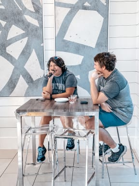 a man and a woman sitting at a table talking