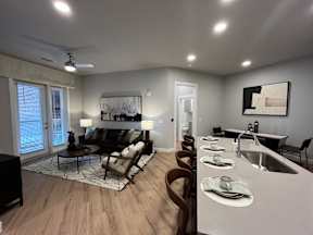 A modern kitchen with a dining table and chairs.