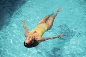 a woman floating in a swimming pool