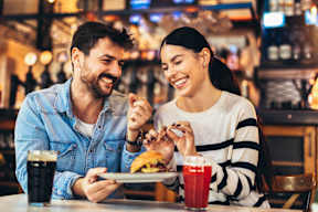 A man and a woman are enjoying a meal together in a restaurant.