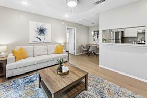 A living room with a white couch and a coffee table.