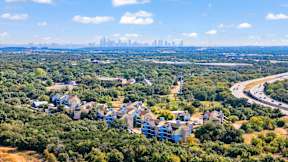 A bird's eye view of a city surrounded by greenery.