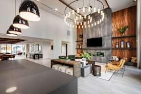 A modern living room with a grey countertop and a fireplace.