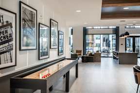 A room with a pool table and a bar.