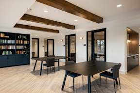 A modern dining room with a large table and chairs.