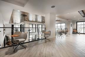 A modern office space with wooden floors and white walls.