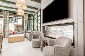 A living room with a fireplace and a flat screen TV.