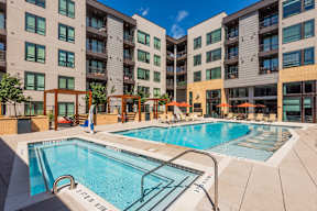 A swimming pool in front of apartment buildings.