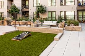 A patio with a fire pit and seating area.