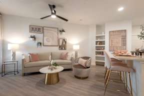 A living room with a couch, chairs, and a coffee table.