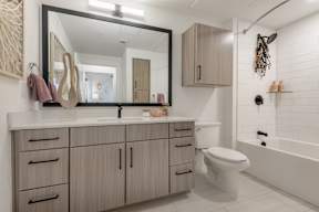 A bathroom with a white tub and sink.