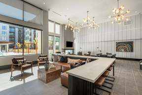 A modern living room with a long table and chairs.