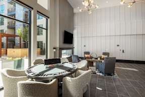 A modern lounge area with a round table and chairs.