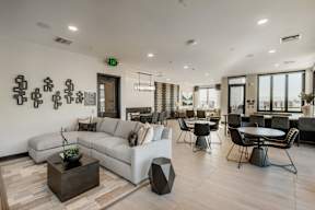 A modern living room with a white sofa, a coffee table, and a fireplace.