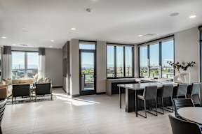 A modern living room with a dining table and chairs.