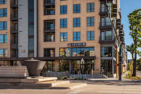 A modern building with a fountain in front of it.