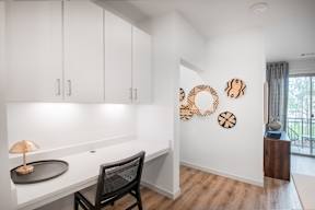 A white room with a desk and chair.