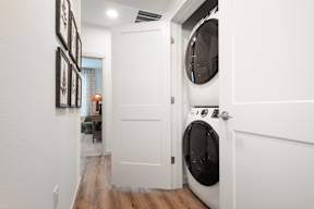 A white door is open to a laundry room.