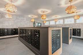 A modern kitchen with black cabinets and wooden accents.