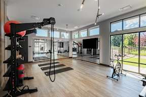 A spacious home gym with a variety of exercise equipment.