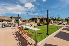 A sunny day at the outdoor seating area of a restaurant with tables and chairs.
