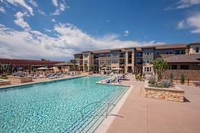 A large swimming pool in front of a building.