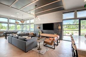A modern living room with a grey sofa and a wooden coffee table.