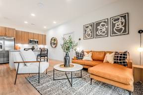 A living room with a white sofa and a coffee table.