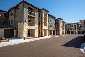 A row of modern apartment buildings with garages.