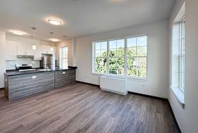 A kitchen with a refrigerator, stove, and oven.