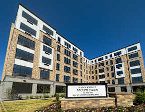 The front of a building with a sign that says "The Sancti Restitutes at Hinchliffe Stadium".