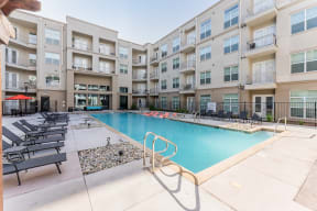 Swimming Pool Area With Shaded Chairs at Residences at 3000 Bardin Road, Grand Prairie, TX, Texas