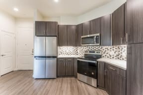 Upscale Stainless Steel Kitchen Appliances With Double Door Refrigerator at Residences at 3000 Bardin Road, Grand Prairie, TX, 75052