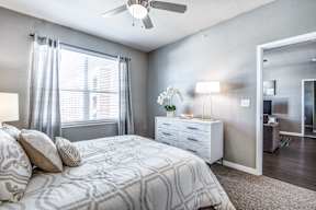 a bedroom with a bed and a ceiling fan at Republic at Alamo Heights, Texas, 78209
