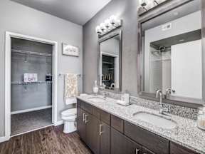 a bathroom with two sinks and a toilet at Republic at Alamo Heights, San Antonio, TX