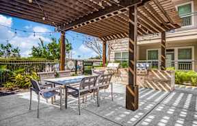 a patio with a table and chairs and a grill at Republic at Alamo Heights, Texas