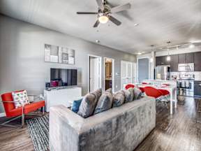 a living room with a couch and a ceiling fan at Republic at Alamo Heights, San Antonio, TX