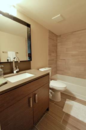A bathroom with a sink, toilet, and bathtub.
