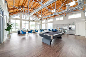a large room with a pool table and chairs