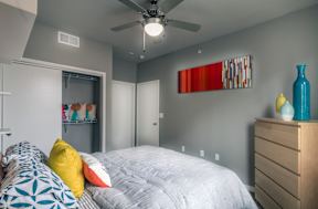 a bedroom with a large bed and a ceiling fan at Republic at Alamo Heights, San Antonio