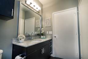 a bathroom with a sink and a mirror at Republic at Alamo Heights, San Antonio, 78209