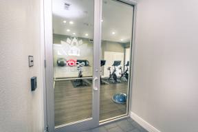 a view of the fitness center from the entrance of the building at Republic at Alamo Heights, San Antonio Texas