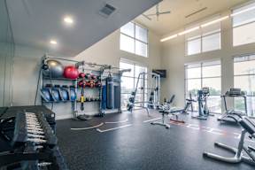 a large fitness room with weights and cardio equipment at Republic at Alamo Heights, San Antonio