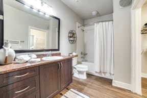 a bathroom with a large mirror and a white shower curtain