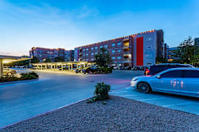 a parking lot with a car parked in front of a building at Republic at Alamo Heights, Texas, 78209