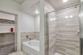 Walk-In Showers With Built-In Bench And Glass Enclosure at Seville at Clay Crossing, Texas