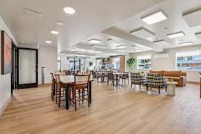 A spacious room with wooden floors and furniture at The Orion Senior Apartments - Orange, CA Apartments, Orange